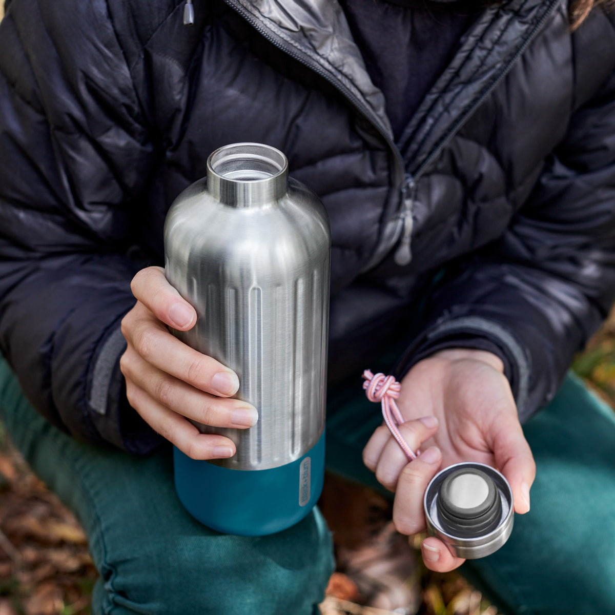 BLACK+BLUM Explorer insulated bottle in orange, large open view showing the sleek design, ideal for hiking and outdoor adventures.