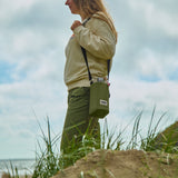 BLACK+BLUM bottle bag in moss green, designed for carrying bottles with a sleek, compact, and durable fabric exterior.