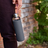 BLACK+BLUM TO-GO GLAS water bottle in ocean blue, 600ml, with sleek glass design and black lid for on-the-go hydration.
