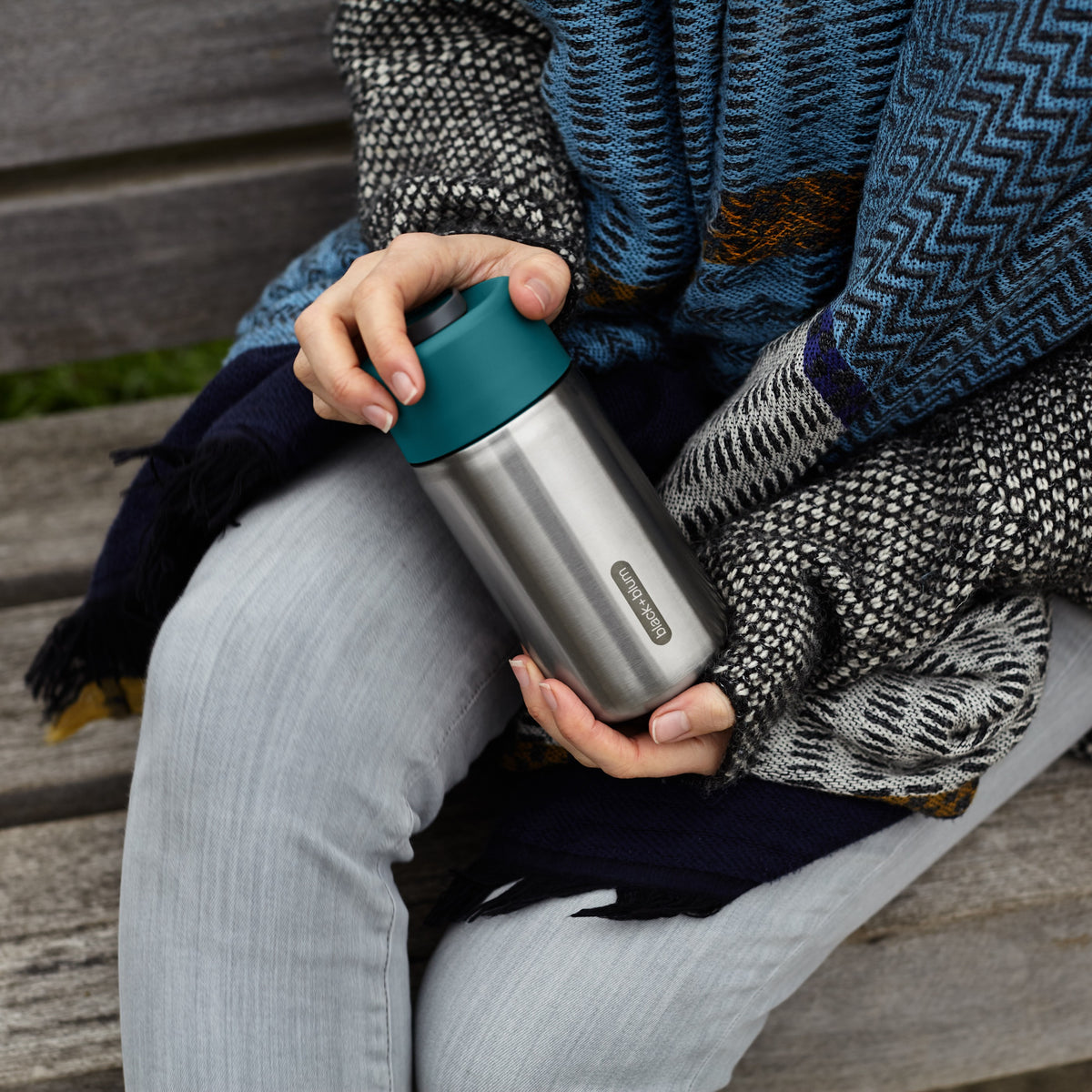 BLACK+BLUM TO-GO insulated thermobecher in orange, 340ml, showing the closed travel cup with secure lid and sleek design.