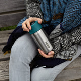 BLACK+BLUM TO-GO insulated thermobecher in orange, 340ml, showing the closed travel cup with secure lid and sleek design.