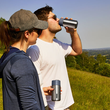 BLACK+BLUM TO-GO thermobecher in orange with a 340 ML capacity, insulated travel cup with black exterior and orange lid.