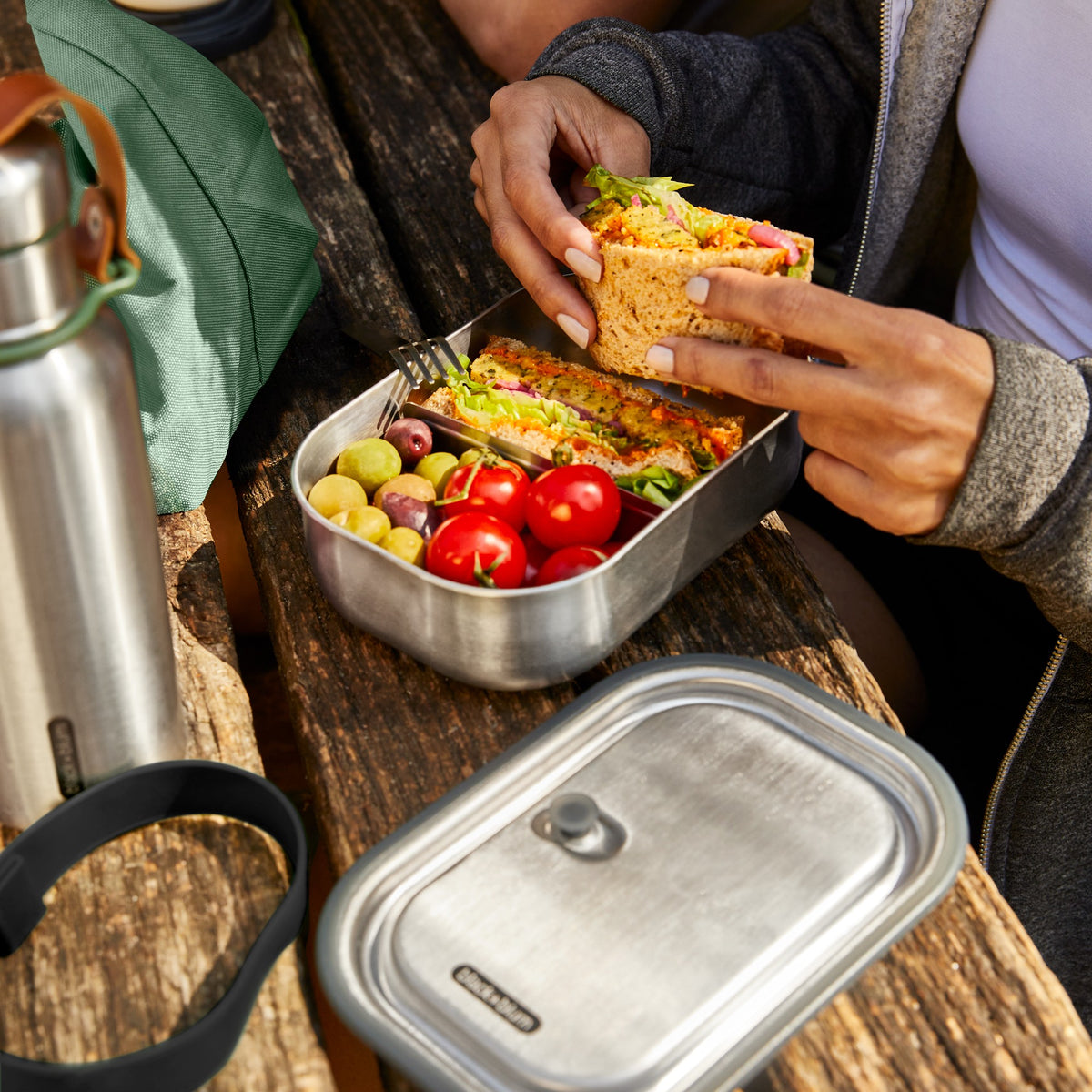 BLACK+BLUM Classic 1000ML steel lunchbox with black exterior, durable design, ideal for carrying meals and snacks.