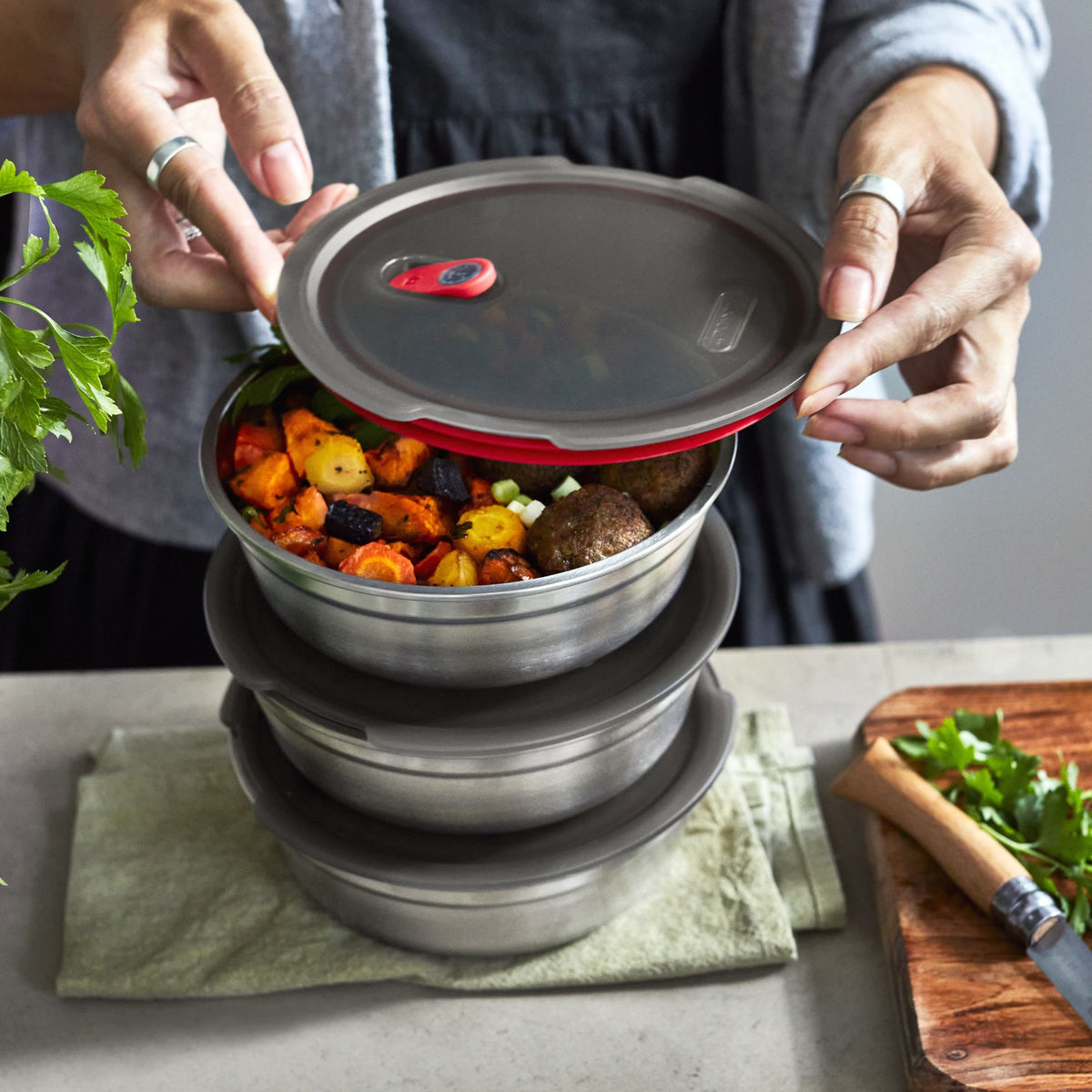 Stacked small BLACK+BLUM stainless steel multifunction storage bowls set of 3, with closed lids, showcasing sleek, modern design.