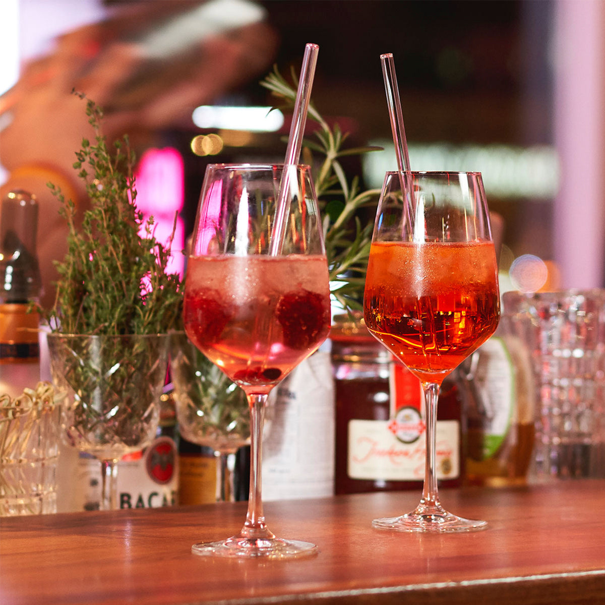 Set of four glass drinking straws in different sizes, transparent and smooth, from Profino Select for eco-friendly beverage use.