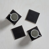 Set of four FREEFORM DUO coasters with modern geometric design, made of durable materials for protecting surfaces.