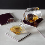 Set of four FREEFORM DUO coasters with modern design, made of durable material, suitable for protecting surfaces from drink spills.
