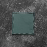 Set of four FREEFORM DUO coasters with modern design, made of durable material, suitable for protecting surfaces from drink spills.